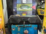 two arcade machines in a room with yellow lockers