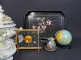 a clock and a picture frame sitting next to each other