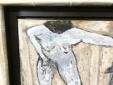 un tableau représentant une femme nue dans un cadre noir et blanc