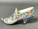a close up of a pair of shoes with flowers on them