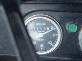 a close up of a car dashboard with a speedometer and gauges