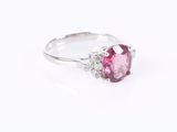 a pink tourmaline and diamond ring on a white background