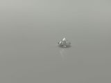 an image of a single diamond on a gray surface
