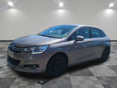 a silver car is parked on a checkered floor in a room