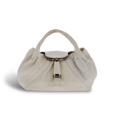 un sac à main blanc muni d'une poignée métallique, sur fond blanc