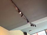 three spotlights that are on the ceiling of a restaurant