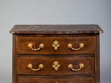 an antique chest of drawers with marble top and brass handles