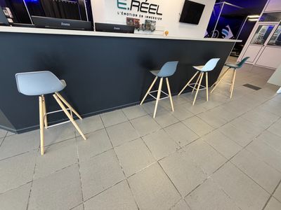 three stools that are sitting in front of a bar