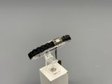 a black and white bracelet with a black bead on it
