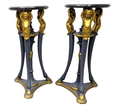 paire de pieds de table noirs et dorés, surmontés d'une tête de lion