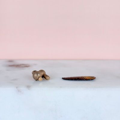 a small piece of food on the counter next to a toothbrush