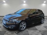 a black car is parked in a room with a checkered floor