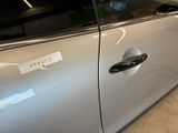 a silver car with a sticker on the side of it