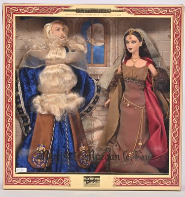 Les deux poupées sont vêtues de costumes médiévaux et se trouvent dans une boîte