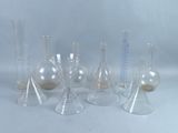 a group of glass vases that are sitting on a table