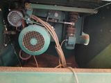 a green machine that is sitting inside of a green container