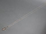 silver plated necklace with a long chain with a bird on it