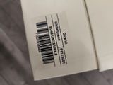 a white box with a barcode on it sitting on the floor