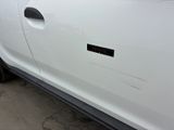a white car with a sticker on the side of it