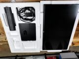 a white box with a laptop and other electronics on top of it