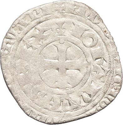 a close up of a coin with a cross on it