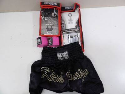 a pair of black boxing shorts with gold writing on them