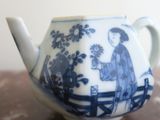 a blue and white tea pot on a table