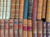 a lot of old books on a shelf in a room