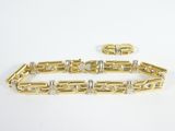 a yellow gold bracelet with diamonds on a white background