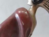a figurine of a woman sitting on a tree branch