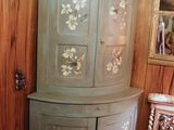 a corner cabinet in the corner of a room