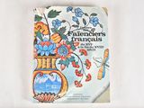 a book with a picture of flowers in a vase