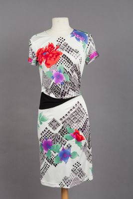 a white dress with colorful flowers on it on a mannequin