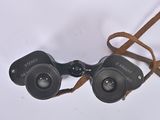 a pair of binoculars that are sitting on a white surface