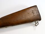 an old rifle with a wooden case on a white surface