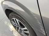 a close up of a car ' s front bumper with a denting on it