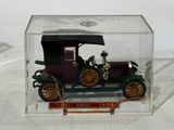 a small toy car in a clear box on a table