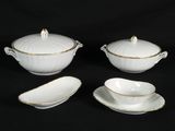 three pieces of white porcelain with gold trims on a black background