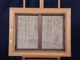 an old wooden easel with a painting on it against a blue background