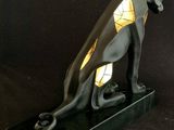 an image of a statue of an egyptian cat on a black background