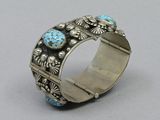 a close up of a silver ring with blue stones on it