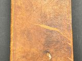 a close up of an old book on a black surface