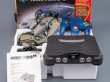 an image of a nintendo 64 game system with controllers and accessories
