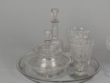 three glasses and a decanter sitting on a tray