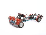 a toy car with a trailer attached to it on a white surface