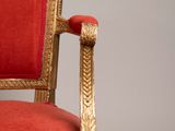 an image of a red and gold chair against a gray background