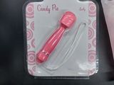 a pink candy pipe in a package next to a toothbrush