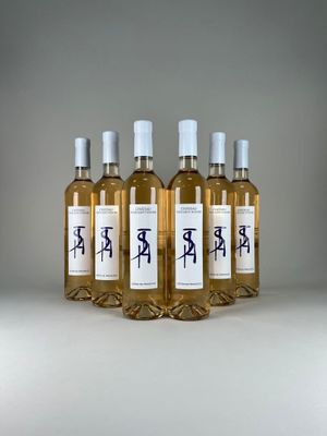 four bottles of wine are lined up on a table