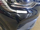 a close up of a car ' s headlight with a sticker on it