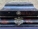 a small wooden box with a lock on it